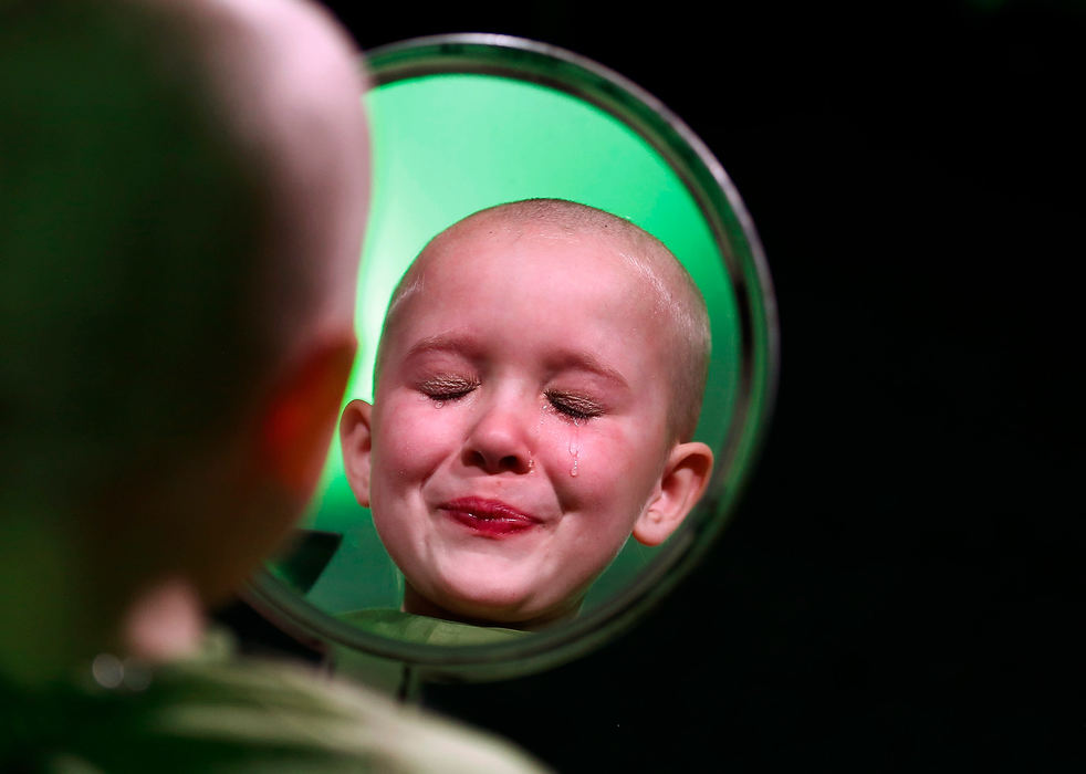 General News - 1st placeNorah Gruzs, 7, recently discovered that a friend she went to pre-school with is again battling brain cancer. So to support her friend, Norah and her mom, Molly, got their heads shaved at Easton's Fado Irish Pub to help raise money for the St. Baldrick's Foundation, which raises money for childhood cancer research. Norah, who with her family raised over $12,000, gets emotional during the event. Norah raised $8,900.87 on her own.(Fred Squillante / The Columbus Dispatch)